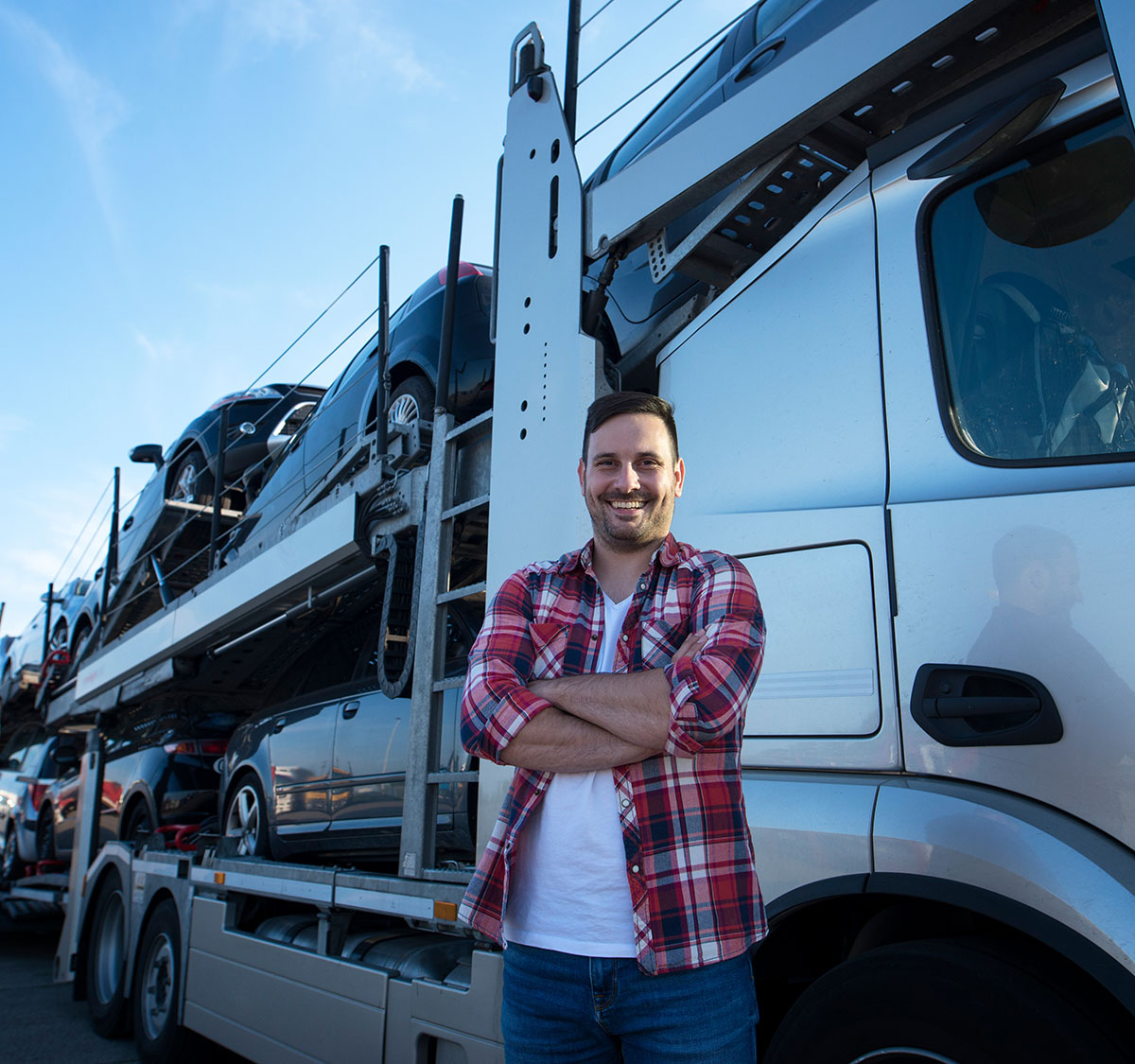 Driver standing in front of truck